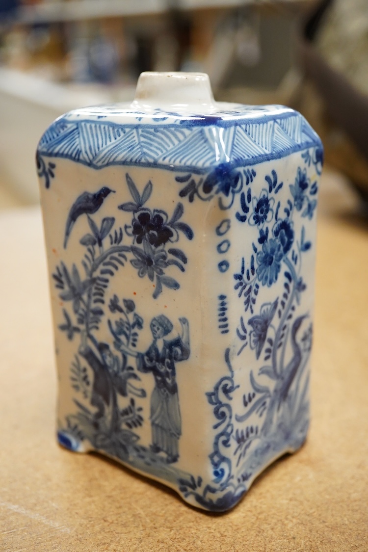 An 18th century Delft tea caddy decorated with figures and flowers and tile, 13cm square